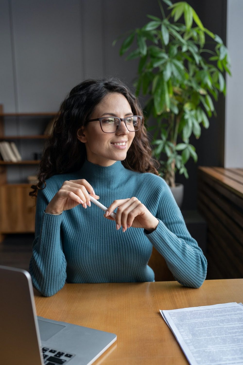 Happy businesswoman entrepreneur look in window smile after successful online laptop video meeting